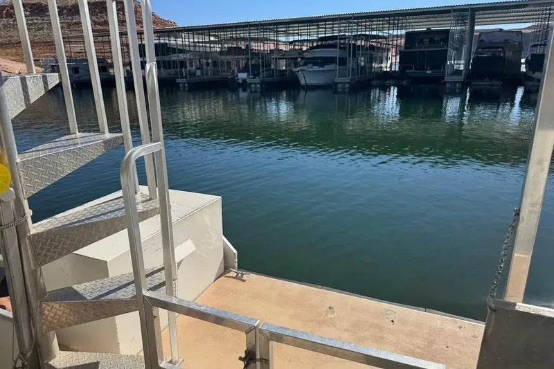Slide: The Image of Staircase on a 2001 Myacht 4815 houseboat docked at a marina. - 9