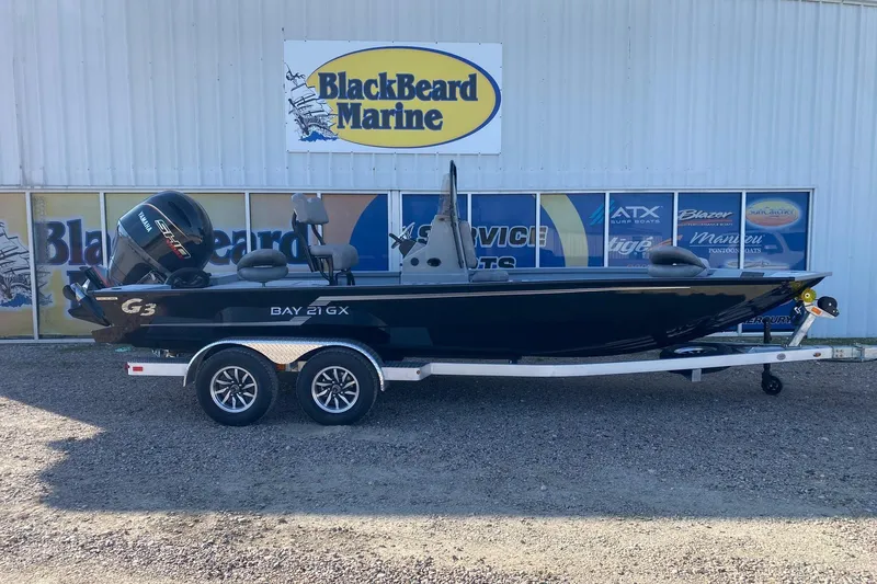 The Image of 2026 G3 Bay 21 GX boat on trailer at BlackBeard Marine dealership. - 1