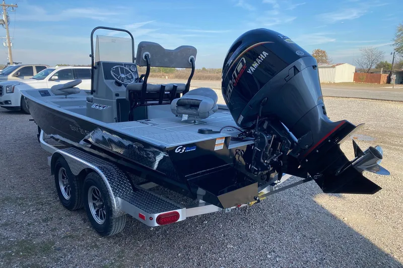 Slide: The Image of 2026 G3 Bay 21 GX boat with Yamaha engine on trailer, parked outdoors. - 4