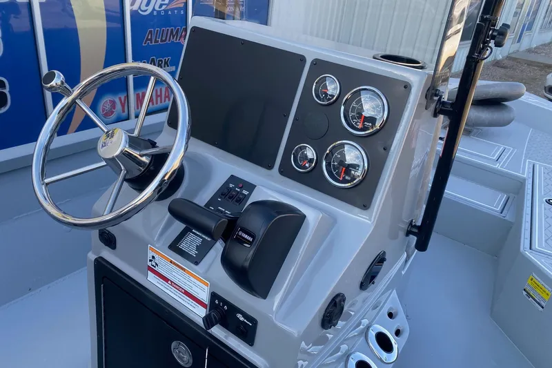 Slide: The Image of 2026 G3 Bay 21 GX boat dashboard with steering wheel and Yamaha controls. - 6