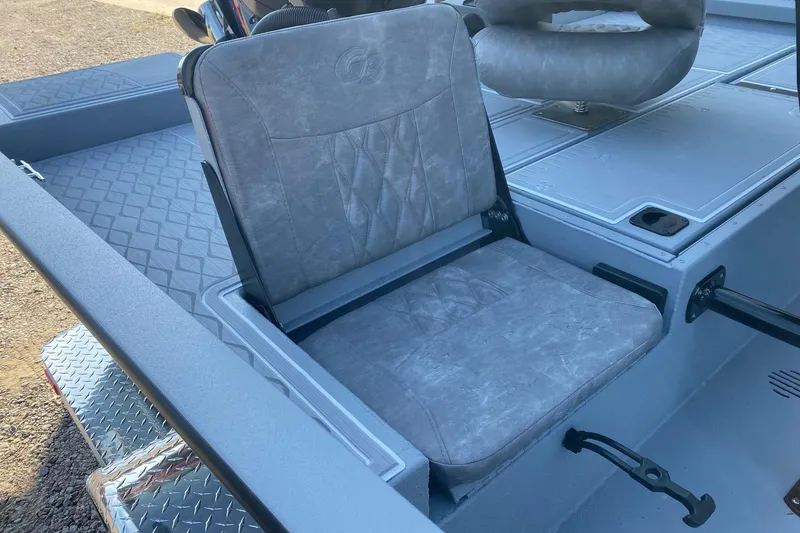 Slide: The Image of 2026 G3 Bay 21 GX boat seat with gray upholstery and diamond-patterned flooring. - 8