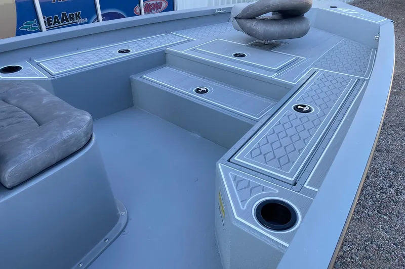 Slide: The Image of 2026 G3 Bay 21 GX boat interior with cushioned seating and storage compartments. - 9