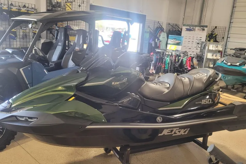 Slide: The Image of 2025 Kawasaki ULTRA 160LX jet ski displayed in a showroom with accessories. - 3