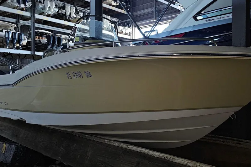 The Image of 2016 Barracuda 188 CCR boat in storage, showcasing sleek design and hull details. - 0