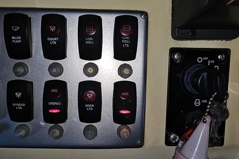 Slide: The Image of Control panel of a 2016 Barracuda 188 CCR boat with various switches and ignition keys. - 11