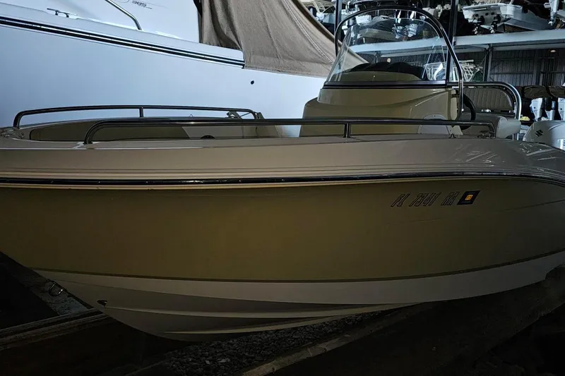 Slide: The Image of 2016 Barracuda 188 CCR boat in storage, side view with visible registration number. - 4