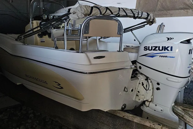 Slide: The Image of 2016 Barracuda 188 CCR boat with Suzuki four-stroke outboard motor in storage. - 6