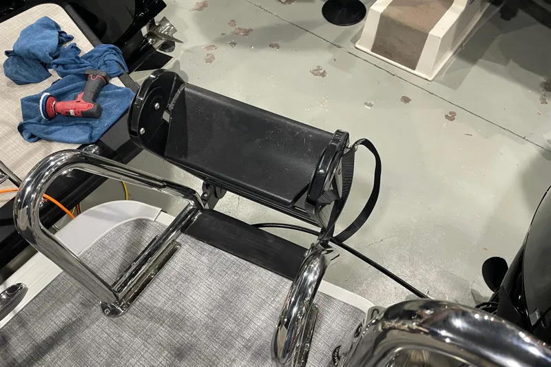 Slide: The Image of 2026 Harris Cruiser 230 CW boat ladder and seat with tools on deck. - 11