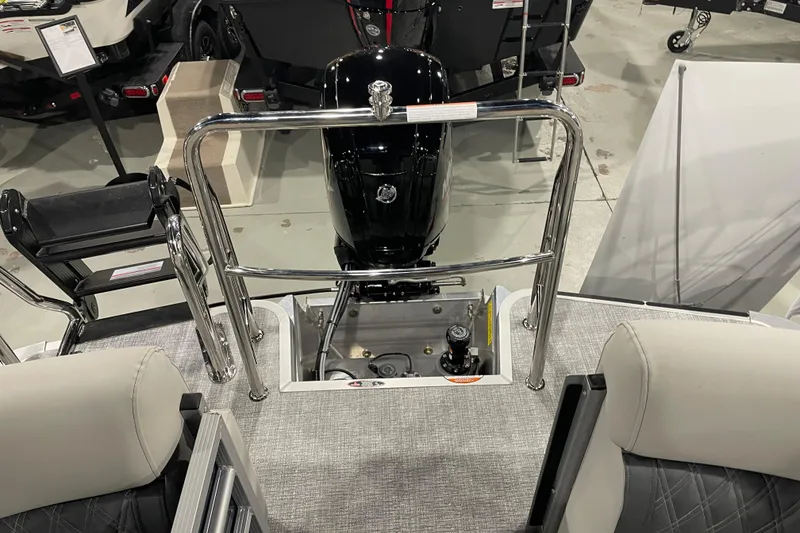 Slide: The Image of 2026 Harris Cruiser 230 CW boat interior with engine and seating, showroom display. - 12