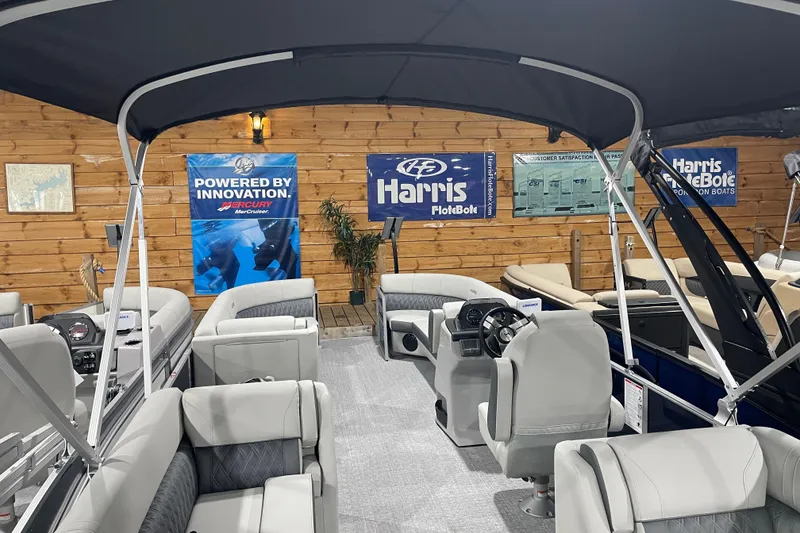 Slide: The Image of 2026 Harris Cruiser 230 CW pontoon boat interior with seating and control console. - 2