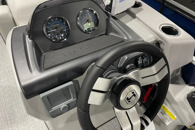 Slide: The Image of Steering console of 2026 Harris Cruiser 230 CW boat with gauges and controls. - 3
