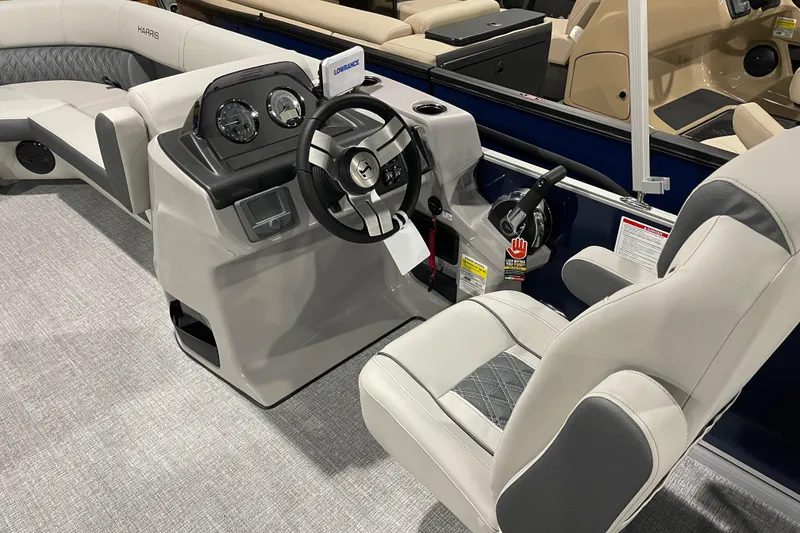 Slide: The Image of 2026 Harris Cruiser 230 CW boat interior with steering console and seating. - 4
