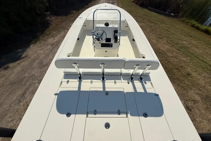Slide: The Image of 2026 Hewes 21 REDFISHER boat, top view, showcasing helm and seating area. - 12