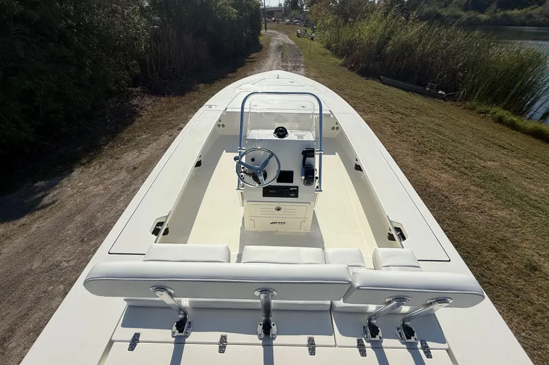 Slide: The Image of 2026 Hewes 21 REDFISHER boat with sleek design, white interior, and central console. - 13