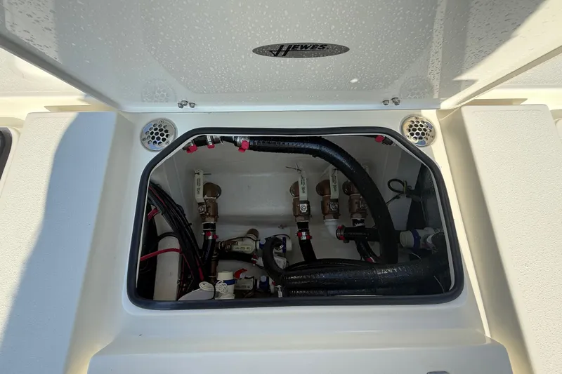 Slide: The Image of 2026 Hewes 21 REDFISHER boat compartment with wiring and plumbing details. - 27