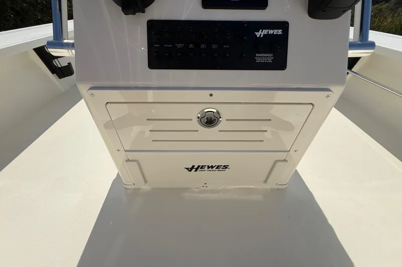 Slide: The Image of 2026 Hewes 21 REDFISHER boat console with control panel and storage compartment. - 30