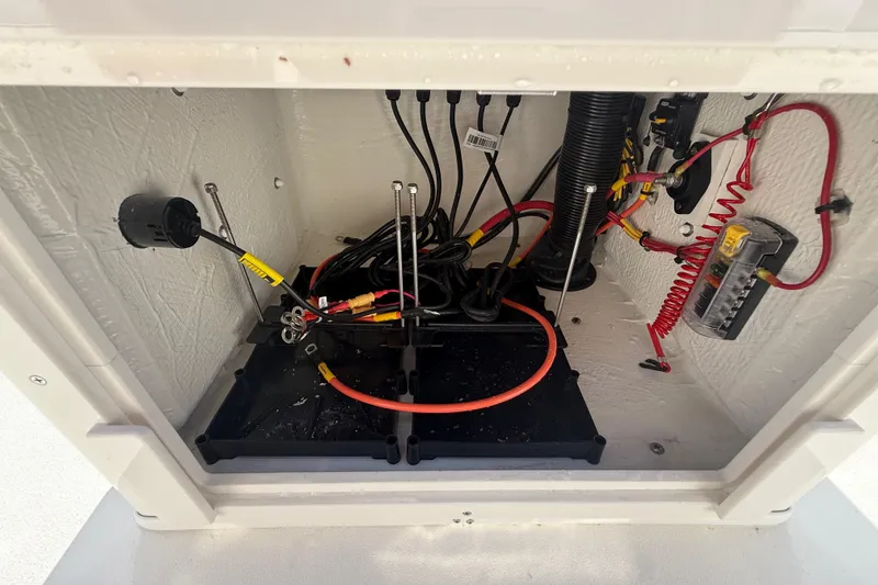 Slide: The Image of 2026 Hewes 21 REDFISHER boat wiring compartment with cables and connectors. - 31