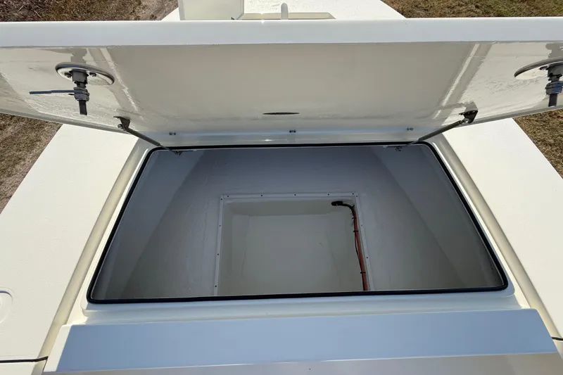 Slide: The Image of Open storage compartment on 2026 Hewes 21 REDFISHER boat, showcasing interior space. - 33