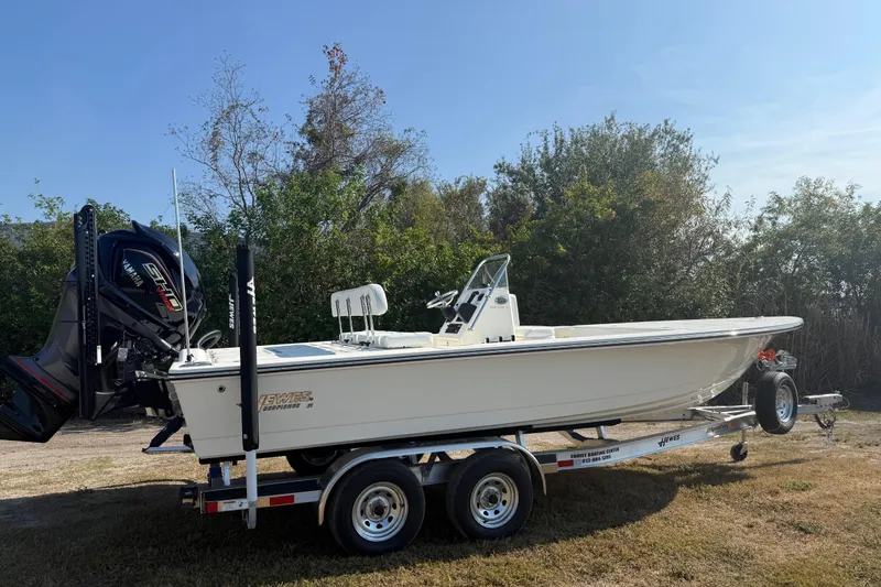 Slide: The Image of 2026 Hewes 21 REDFISHER boat on trailer, parked outdoors, side view. - 7