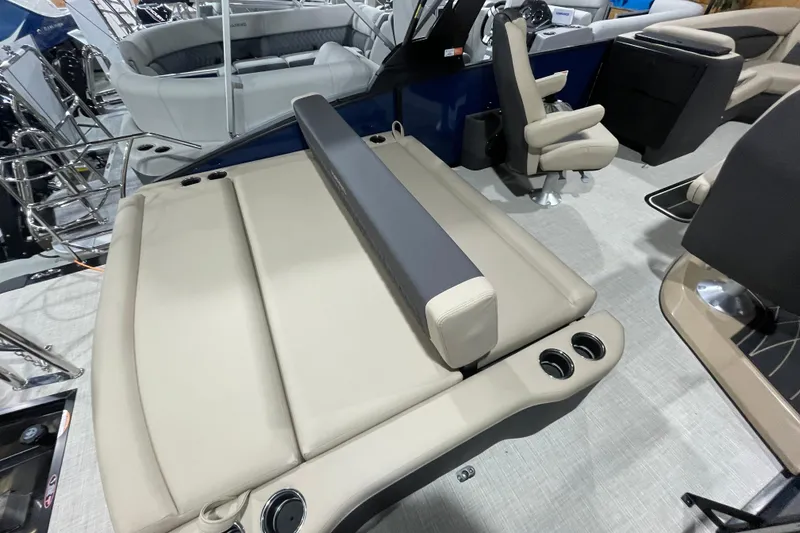 Slide: The Image of 2026 Harris SUNLINER 230 SLDH boat interior with beige seating and cup holders. - 16