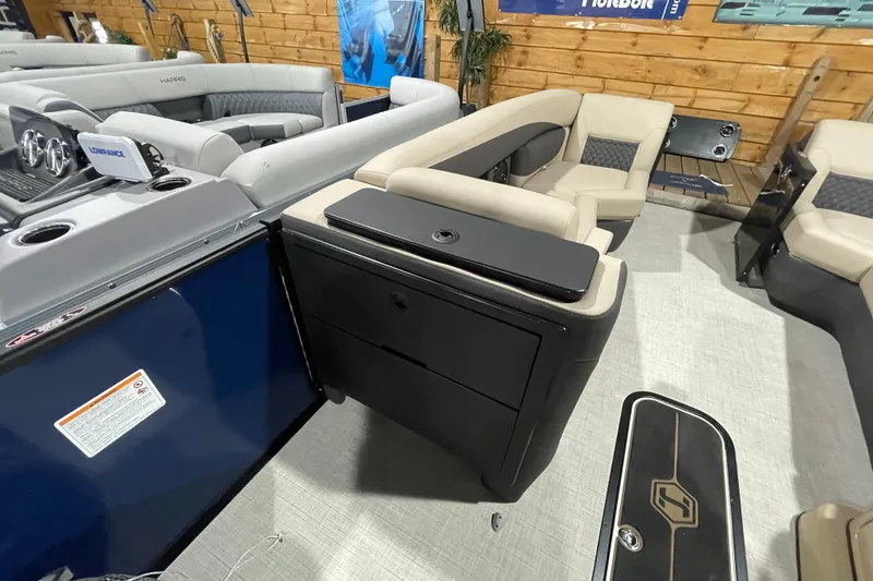 Slide: The Image of 2026 Harris SUNLINER 230 SLDH boat interior with beige seating and modern dashboard. - 18