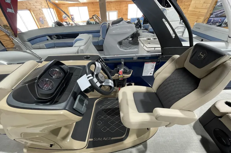 Slide: The Image of 2026 Harris SUNLINER 230 SLDH boat interior with steering console and luxurious seating. - 21