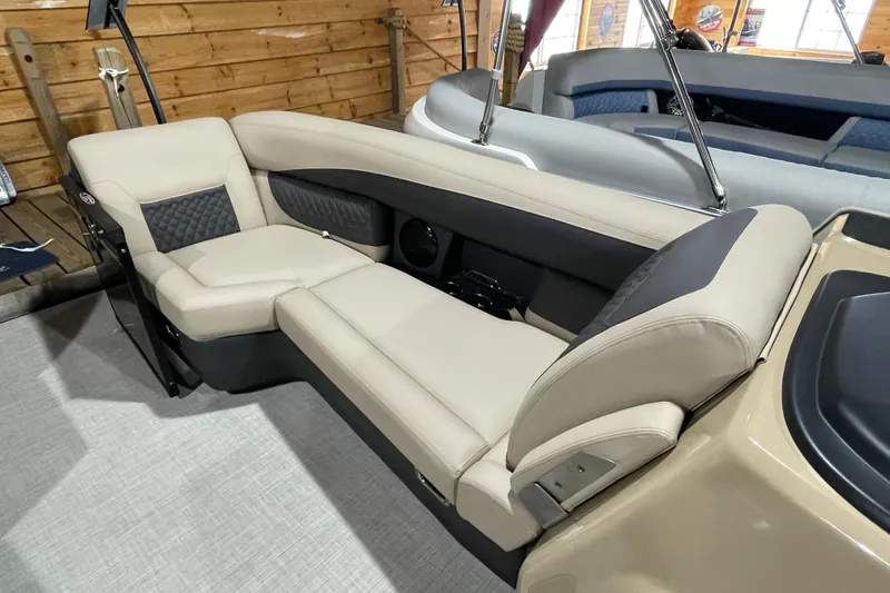 Slide: The Image of 2026 Harris SUNLINER 230 SLDH boat interior with beige seating and wood paneling. - 22