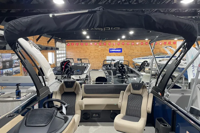 Slide: The Image of 2026 Harris SUNLINER 230 SLDH pontoon boat interior in showroom, featuring luxurious seating and modern design. - 5