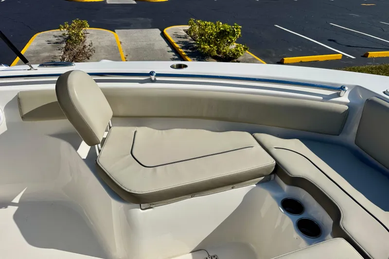 Slide: The Image of 2023 Key West 239 FS boat interior with beige seating and cup holders. - 10