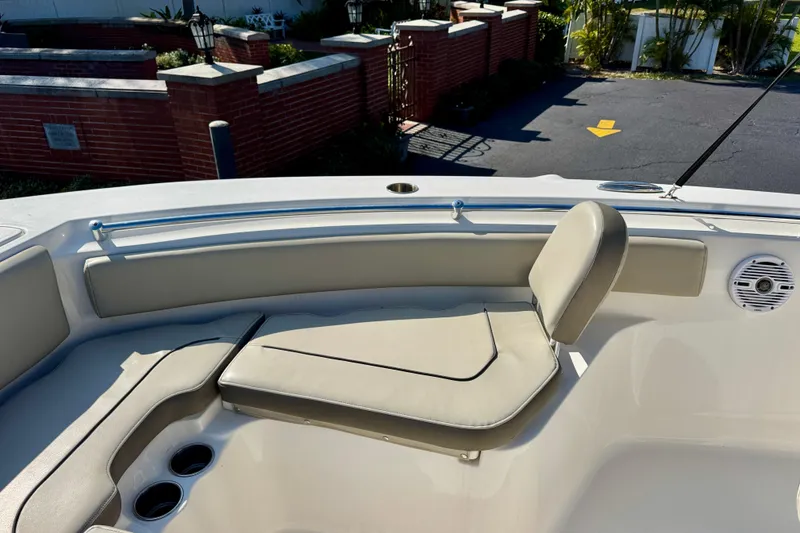 Slide: The Image of 2023 Key West 239 FS boat interior with cushioned seating and cup holders. - 11