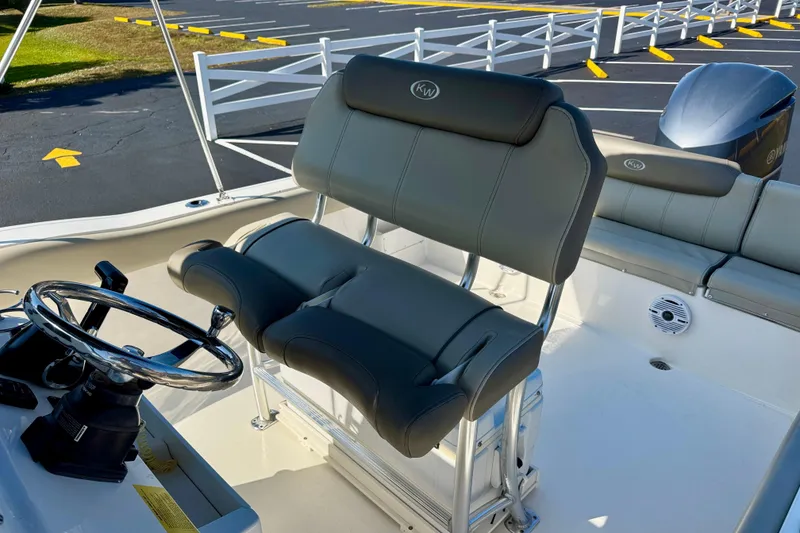 Slide: The Image of 2023 Key West 239 FS boat interior with steering wheel and seating. - 14