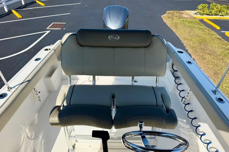 Slide: The Image of 2023 Key West 239 FS boat interior with dual seating and steering wheel. - 15
