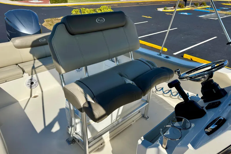 Slide: The Image of 2023 Key West 239 FS boat interior with helm, seating, and steering wheel. - 16
