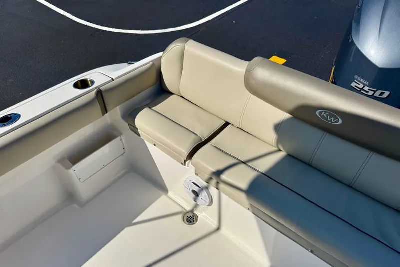 Slide: The Image of 2023 Key West 239 FS boat interior with cushioned seating and Yamaha 250 engine. - 26