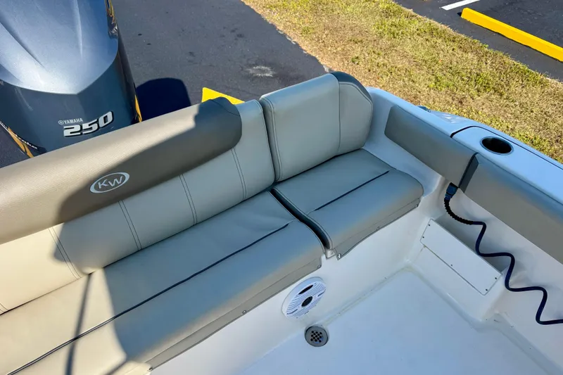 Slide: The Image of 2023 Key West 239 FS boat interior with Yamaha 250 engine, featuring cushioned seating. - 27