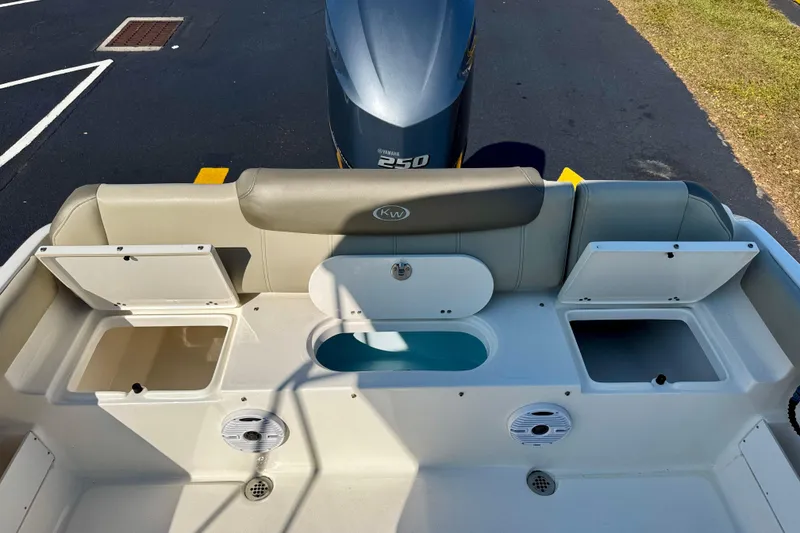 Slide: The Image of 2023 Key West 239 FS boat interior with storage compartments and Yamaha 250 engine. - 28