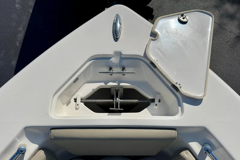 Slide: The Image of 2023 Key West 239 FS boat anchor compartment with open hatch, showcasing storage space. - 36