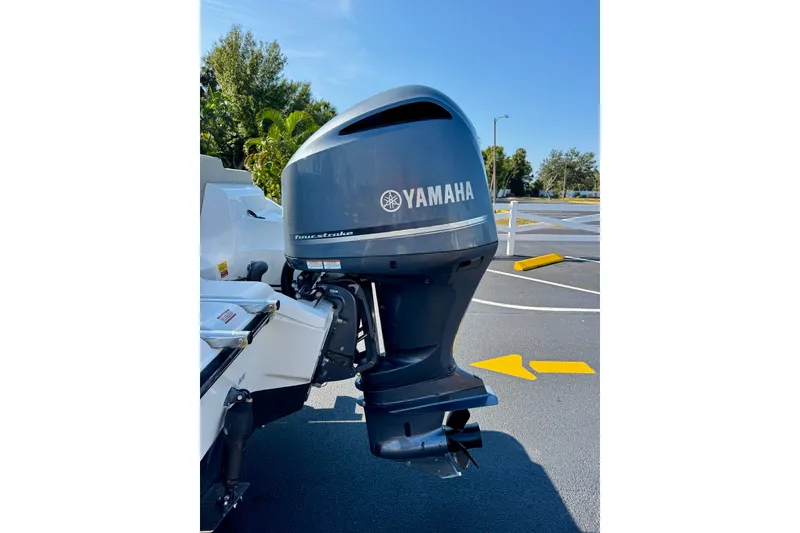 Slide: The Image of 2023 Key West 239 FS boat with Yamaha outboard motor in a parking lot. - 37