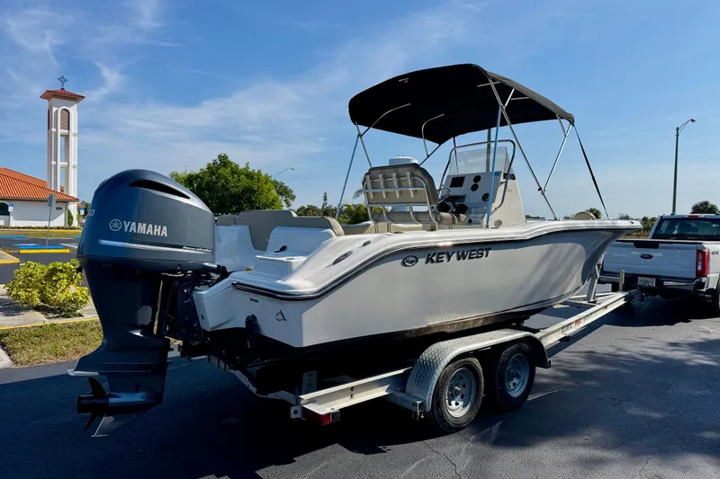 Slide: The Image of 2023 Key West 239 FS boat on trailer with Yamaha engine, parked outdoors. - 5