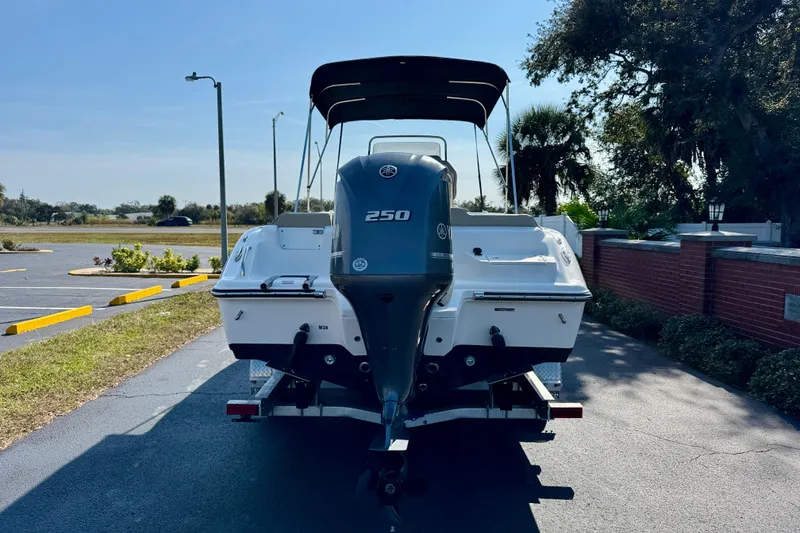 Slide: The Image of 2023 Key West 239 FS boat with 250 horsepower engine, parked outdoors. - 6