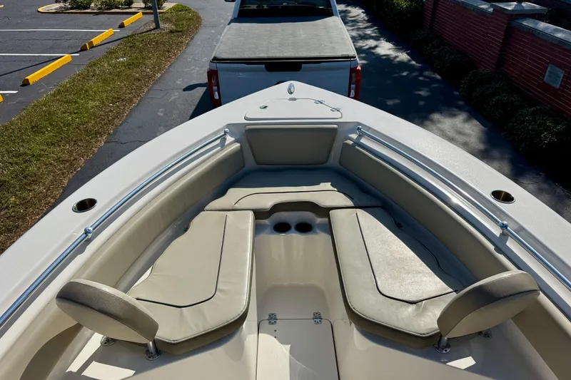 Slide: The Image of 2023 Key West 239 FS boat interior with cushioned seating and cup holders. - 9