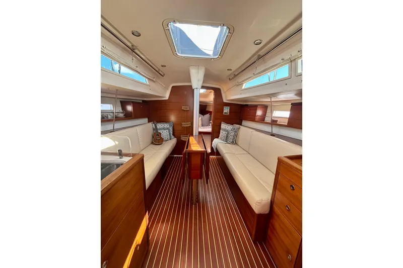 Slide: The Image of Interior of 2015 Salona 35 yacht with elegant wood finish and white seating. - 15