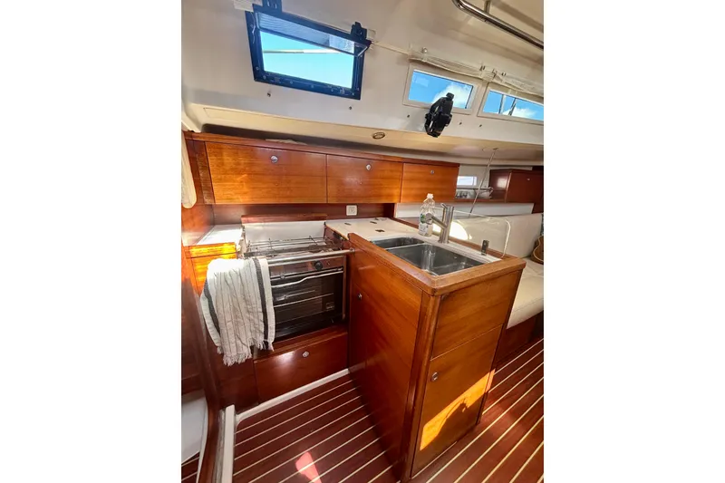 Slide: The Image of Interior of 2015 Salona 35 yacht with wooden cabinetry and compact kitchen area. - 21