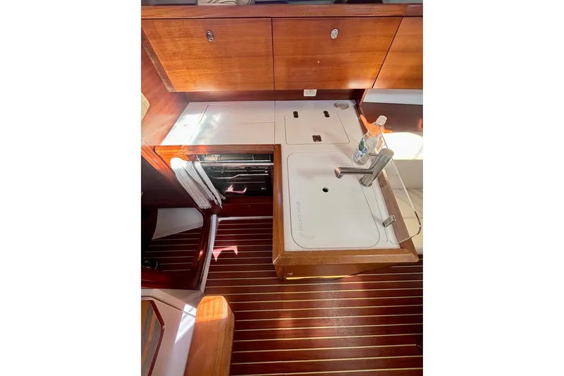 Slide: The Image of Interior of 2015 Salona 35 yacht kitchen with wooden cabinets and sink. - 22