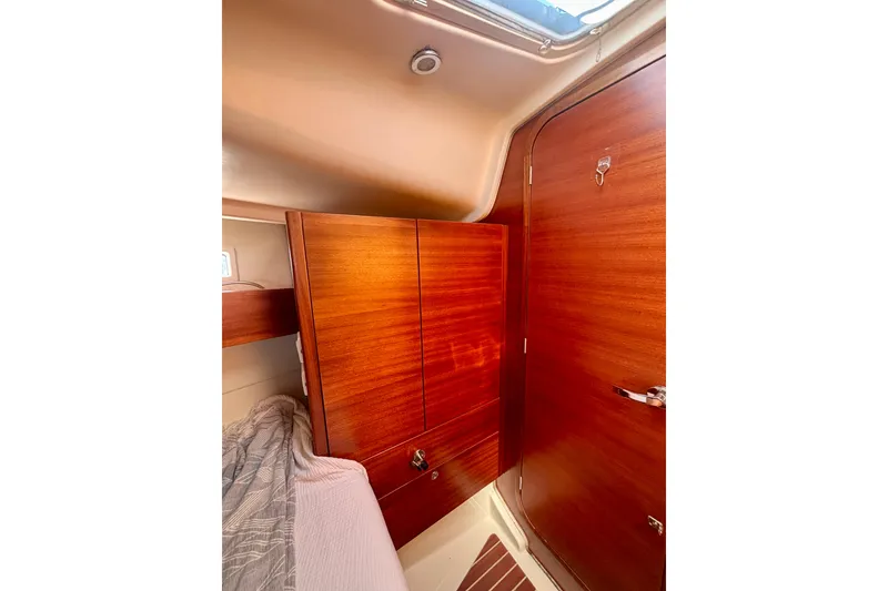 Slide: The Image of Interior of 2015 Salona 35 yacht with wooden cabinetry and cozy sleeping area. - 24
