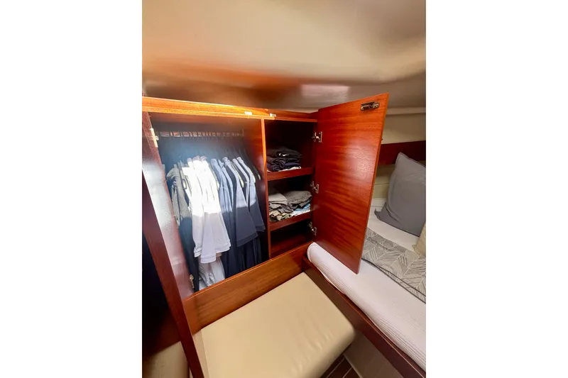 Slide: The Image of Cozy cabin interior of 2015 Salona 35 yacht with open wardrobe and bed. - 25