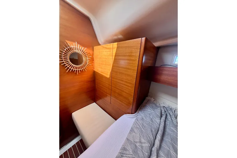 Slide: The Image of Cozy cabin interior of 2015 Salona 35 yacht with wooden paneling and decorative mirror. - 26