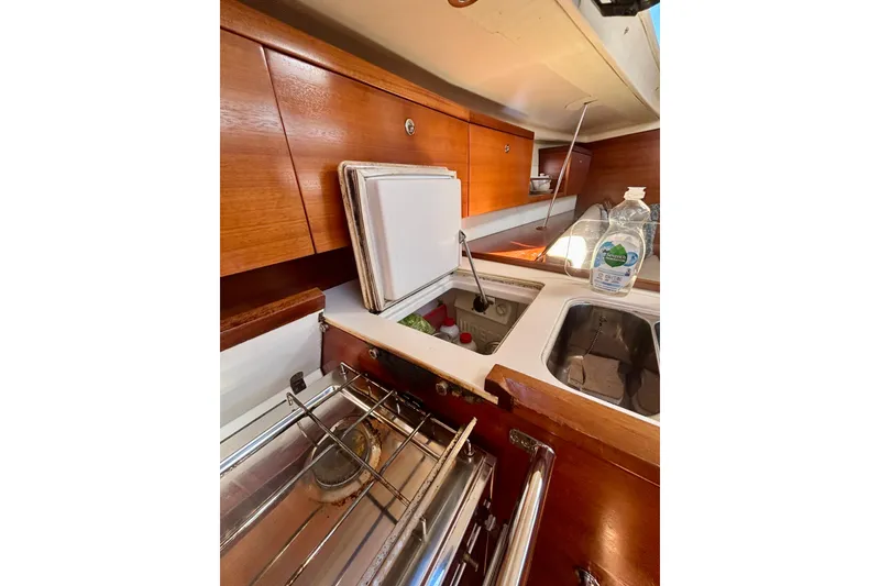 Slide: The Image of Interior of 2015 Salona 35 yacht kitchen with wooden cabinets and sink. - 32