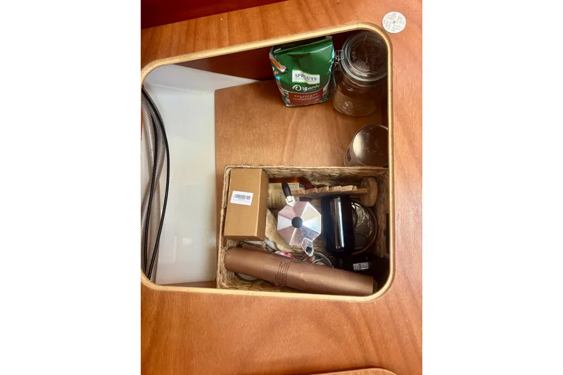 Slide: The Image of Storage compartment on a 2015 Salona 35 yacht with kitchen items and coffee supplies. - 35
