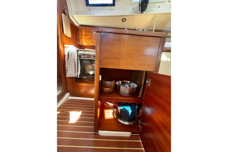 Slide: The Image of Interior of 2015 Salona 35 sailboat with wooden cabinetry and kitchen essentials. - 37
